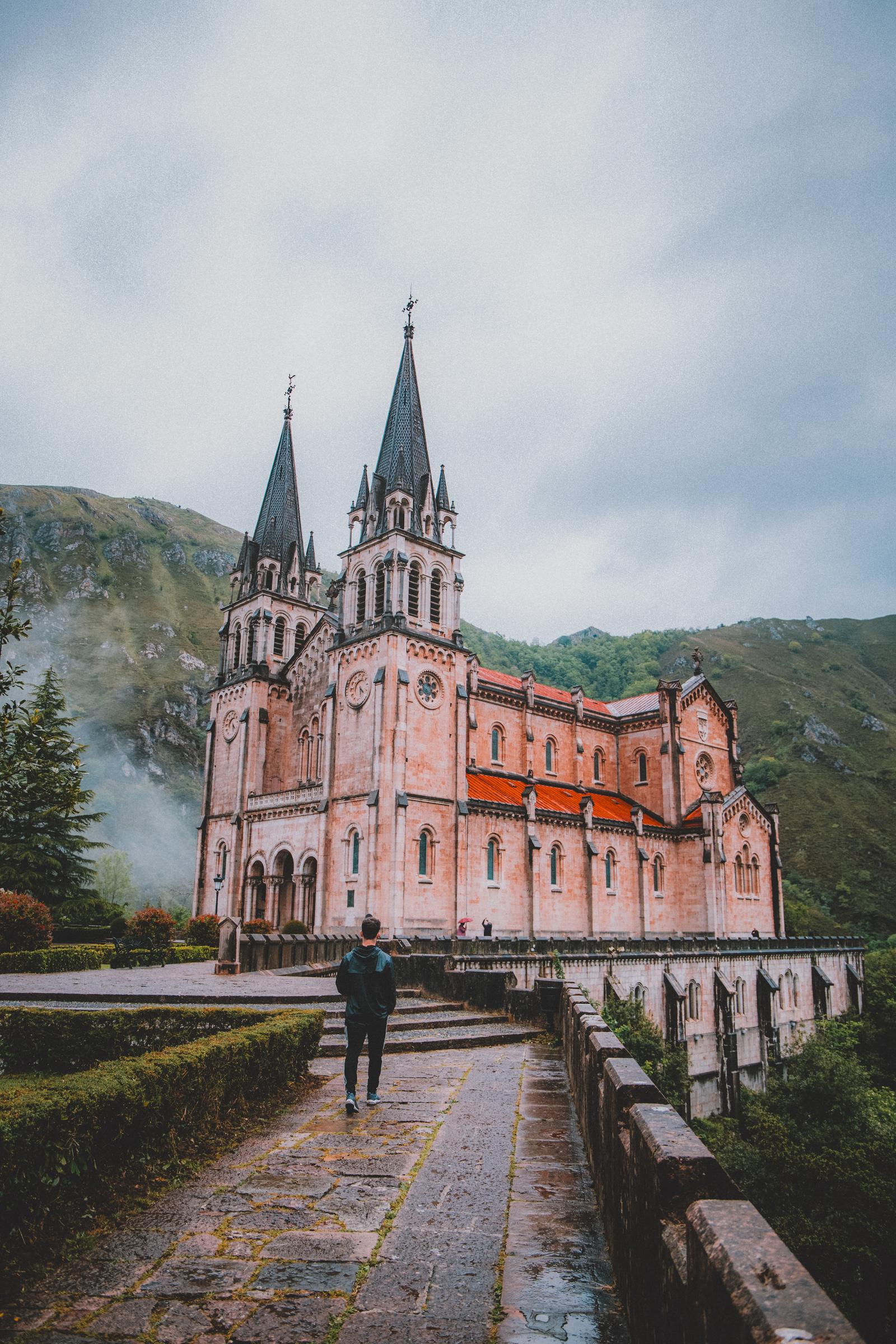 Walking up to the Basilica of Covadonga as mist rolls off the Asturian hills.
